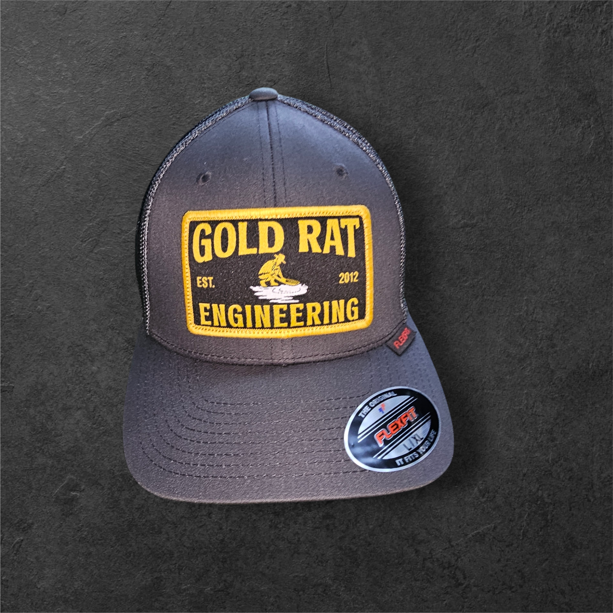 FLEXFIT® Mesh Trucker Cap | CHARCOAL Gold rat Engineering