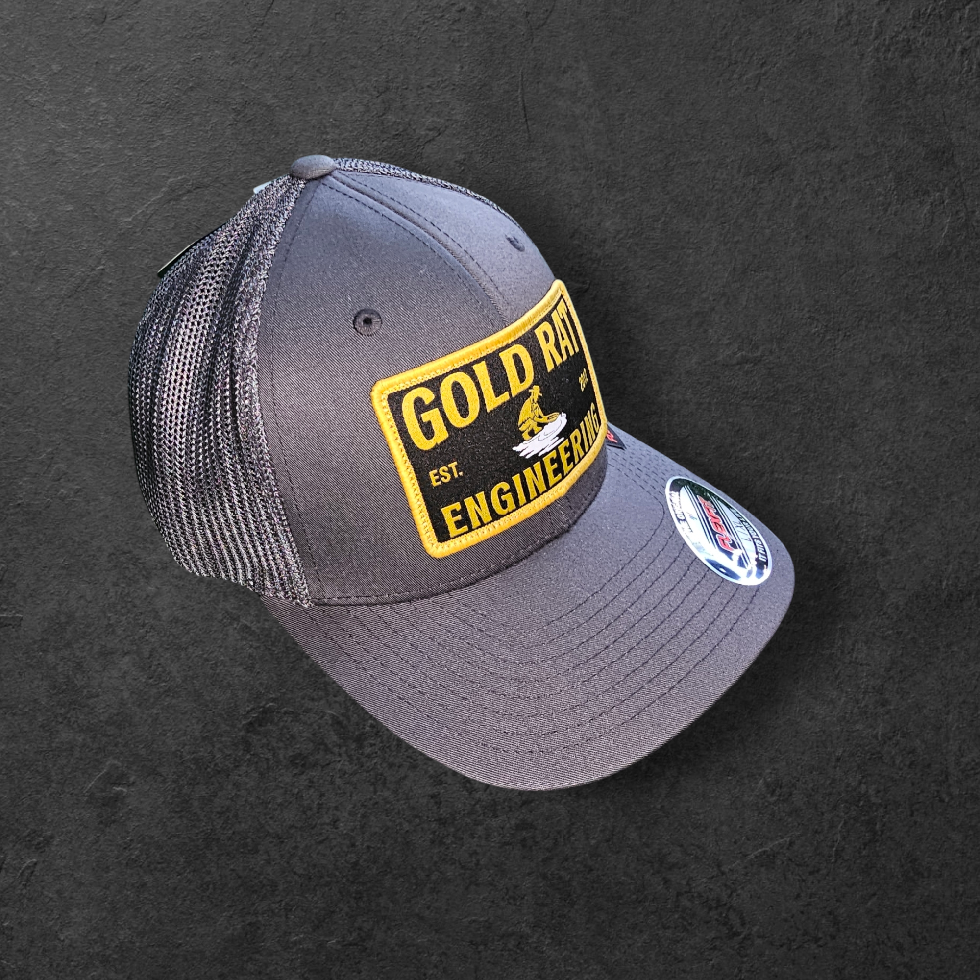 FLEXFIT® Mesh Trucker Cap | CHARCOAL Gold rat Engineering